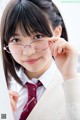 A young woman wearing glasses and a red tie.