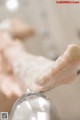 A close up of a person's hand in a glass of water.