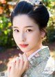 A woman in a kimono poses for a picture. 