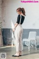 a woman standing in front of a white chair